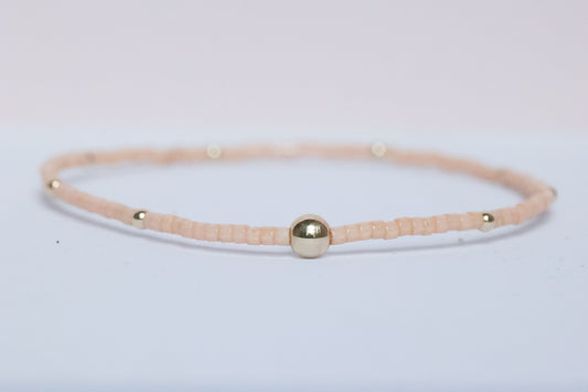 The Natural Glam Pinky Peach Bracelet from the hope bead co. Japanese glass and 14-karat gold filled beads on stretch bracelet.