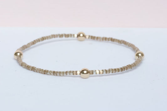 The Natural Glam Tortoise Bracelet from the hope bead co. Japanese glass and 14-karat gold filled beads on stretch bracelet.