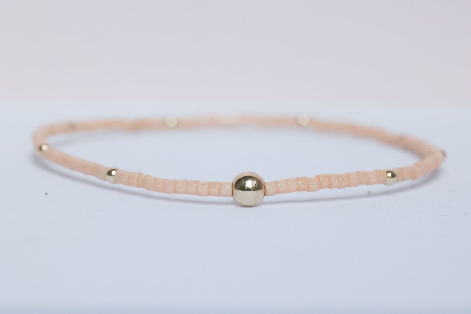 The Natural Glam Pinky Peach Bracelet from the hope bead co. Japanese glass and 14-karat gold filled beads on stretch bracelet.